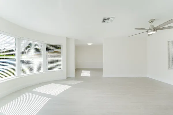 a view of a livingroom with a ceiling fan and window