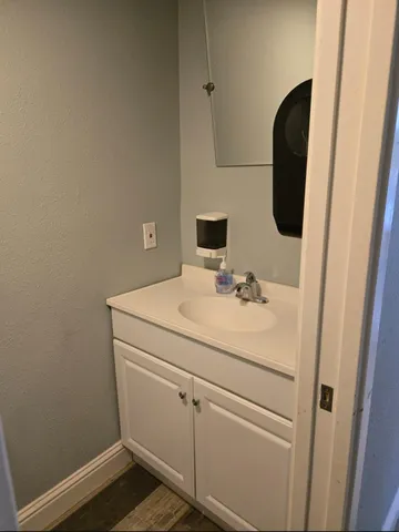 a white toilet sitting next to a white wall