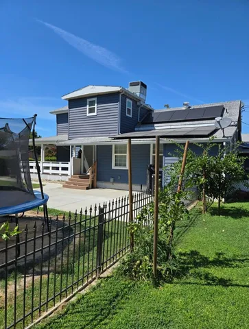 a view of a kitchen with kitchen island a sink wooden floor and glass window