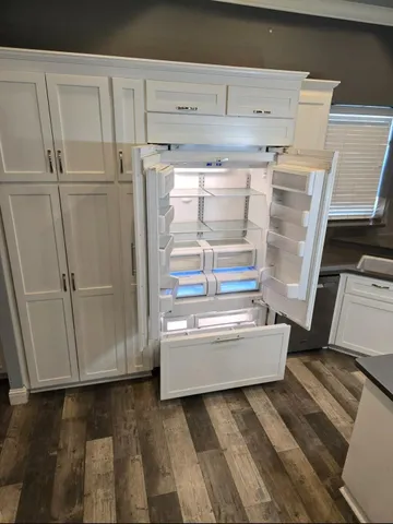 a kitchen with a sink stainless steel appliances and cabinets