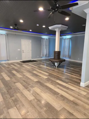 a view of empty room with wooden floor
