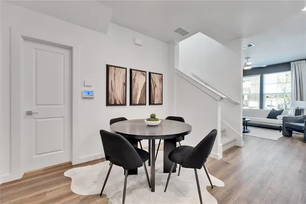 a view of a dining room with furniture and wooden floor