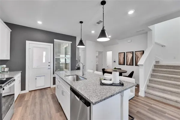 a kitchen with sink and refrigerator
