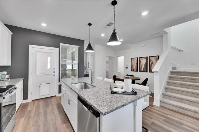 a kitchen with sink and refrigerator