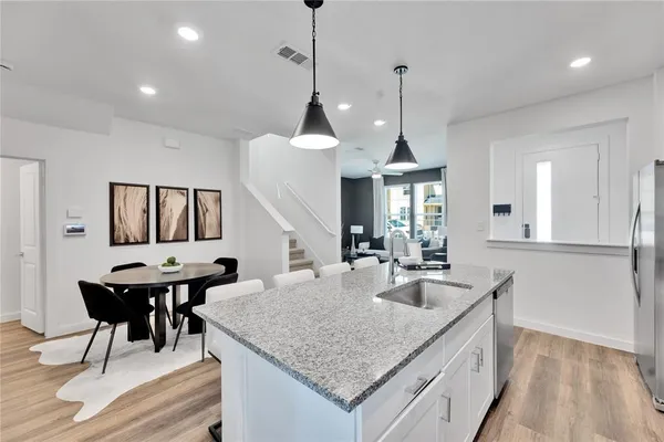 a kitchen with center island and stainless steel appliances