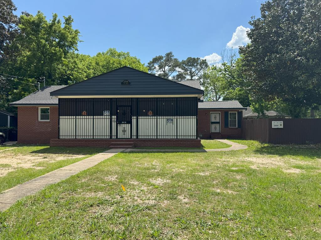 a backyard of a house with yard and outdoor seating