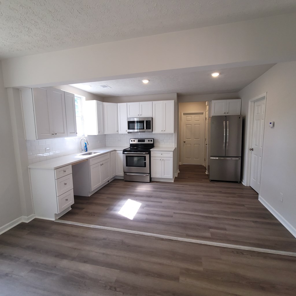 2704 Lee Street, Unit B1 Columbus, GA 31903 - Photo 4 of 7 a view of kitchen with wooden floor and electronic appliances