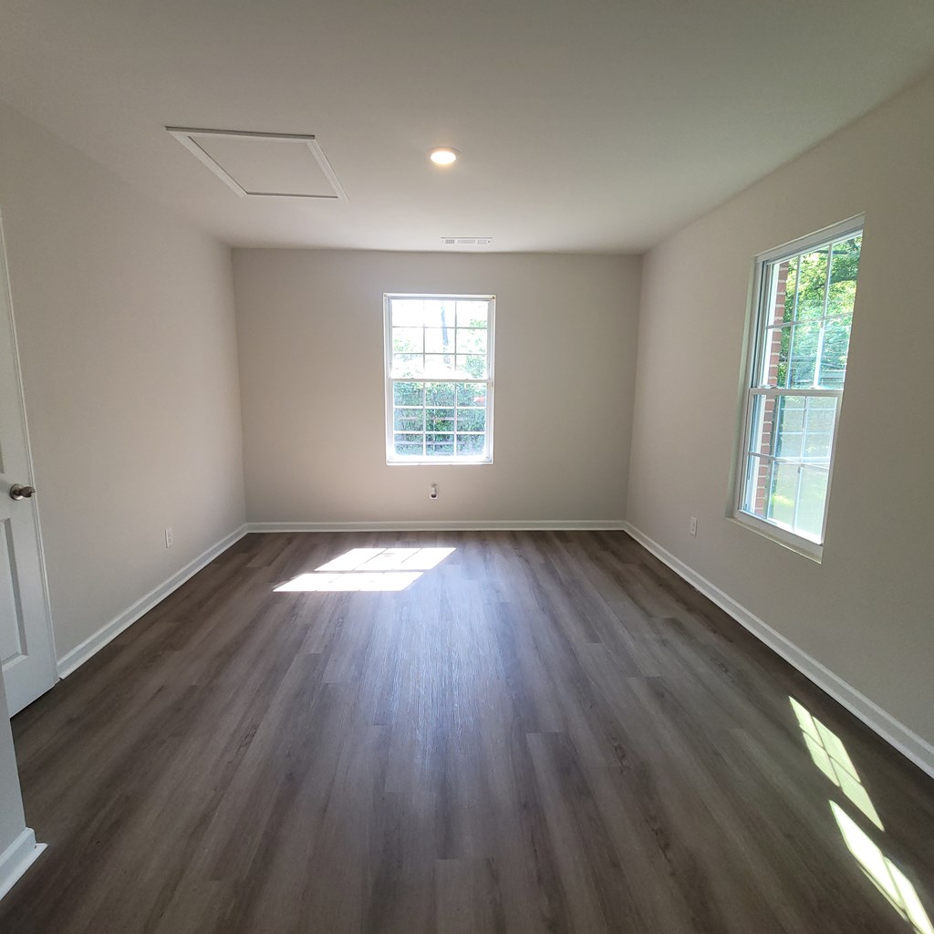 2704 Lee Street, Unit B1 Columbus, GA 31903 - Photo 6 of 7 an empty room with wooden floor and windows