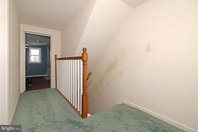 a bedroom with a bed and a dresser with mirror