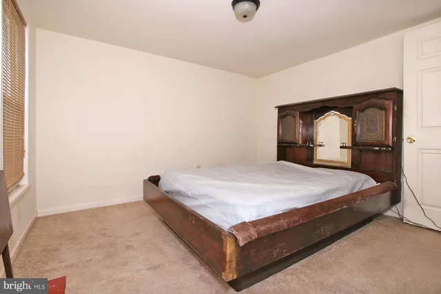 a bedroom with a bed and a chair