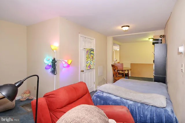 a bedroom with furniture and a potted plant