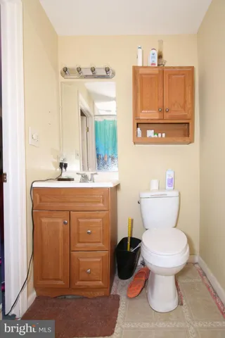 a bathroom with a toilet sink and mirror