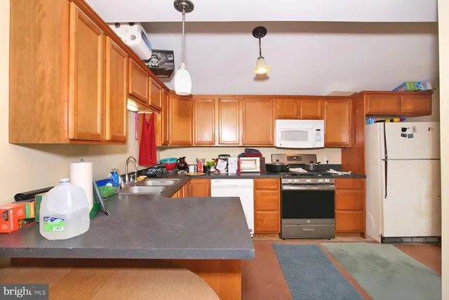 a kitchen with stainless steel appliances granite countertop a sink refrigerator and stove