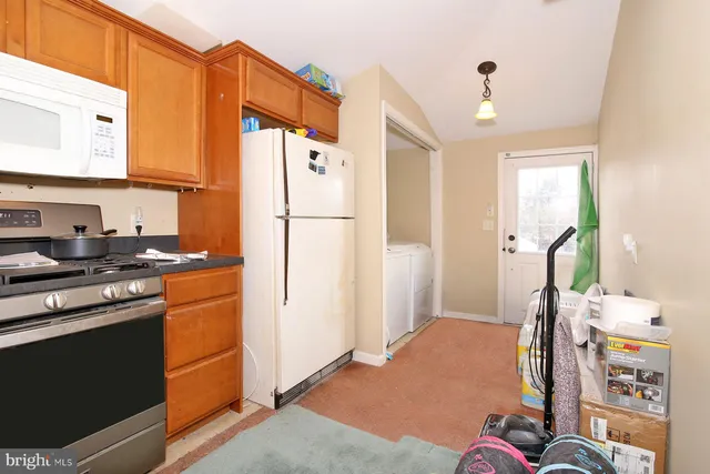 a kitchen with stainless steel appliances a refrigerator and a stove