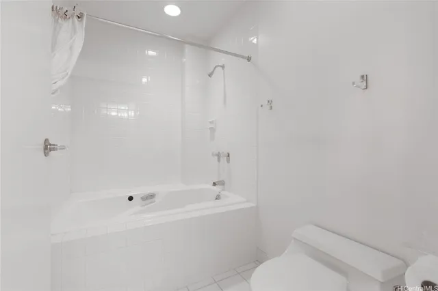 a white bath tub sitting next to a white toilet