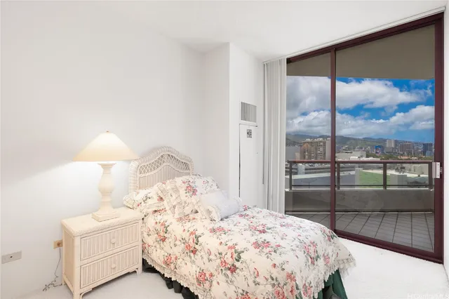 a bedroom with a large bed and a lamp next to a window