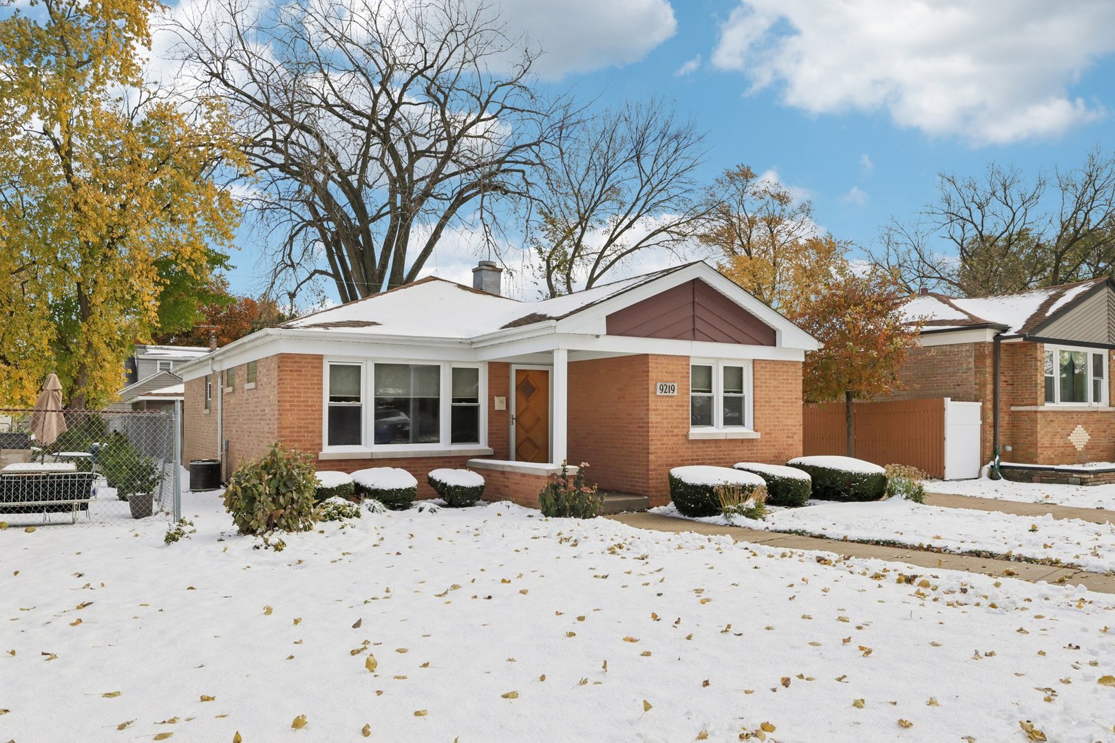 9219 South Spaulding Avenue Evergreen Park, IL 60805 - Photo 3 of 23 a front view of a house with yard covered in snow