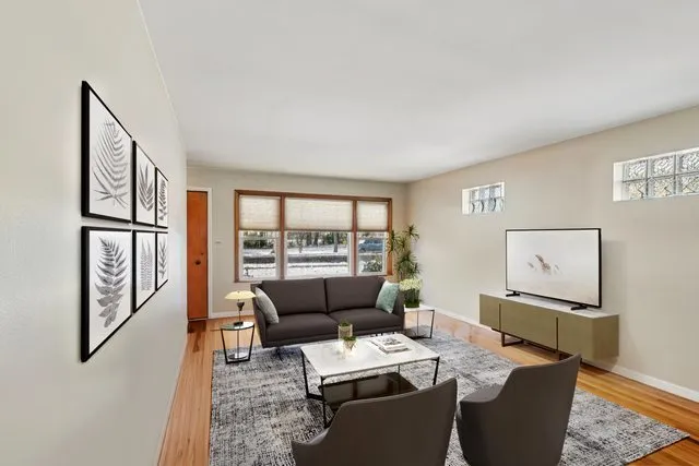 a living room with furniture and a floor to ceiling window