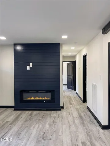 an empty room with wooden floor