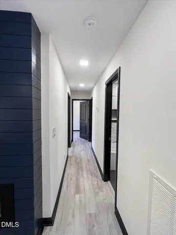 a view of an empty room with wooden floor