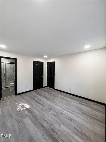 a bathroom with a toilet a sink a mirror and a shower