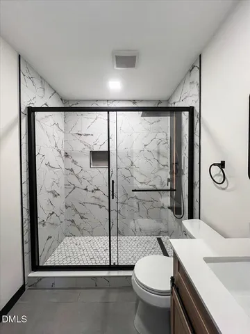 an empty room with wooden floor and closet