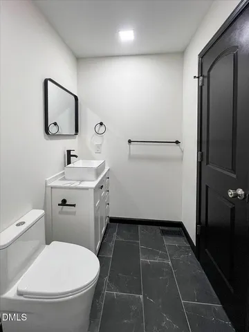 a bathroom with a toilet a sink and bathtub