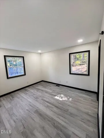 a view of dirt yard with a large tree