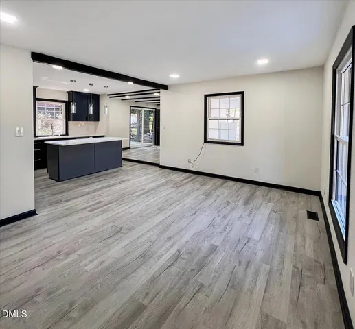 a view of kitchen with stainless steel appliances granite countertop a stove and a refrigerator