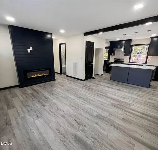 a kitchen with kitchen island a sink and a stove