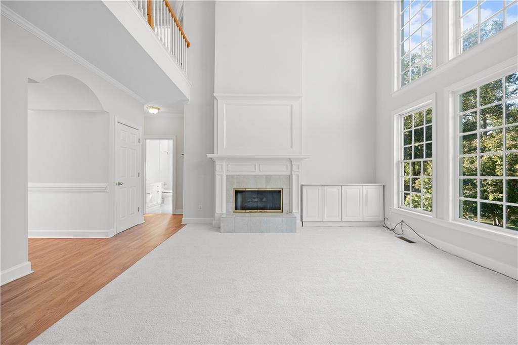 1810 Sunset Harbour Pointe Lawrenceville, GA 30043 - Photo 19 of 56 an empty room with windows and fireplace