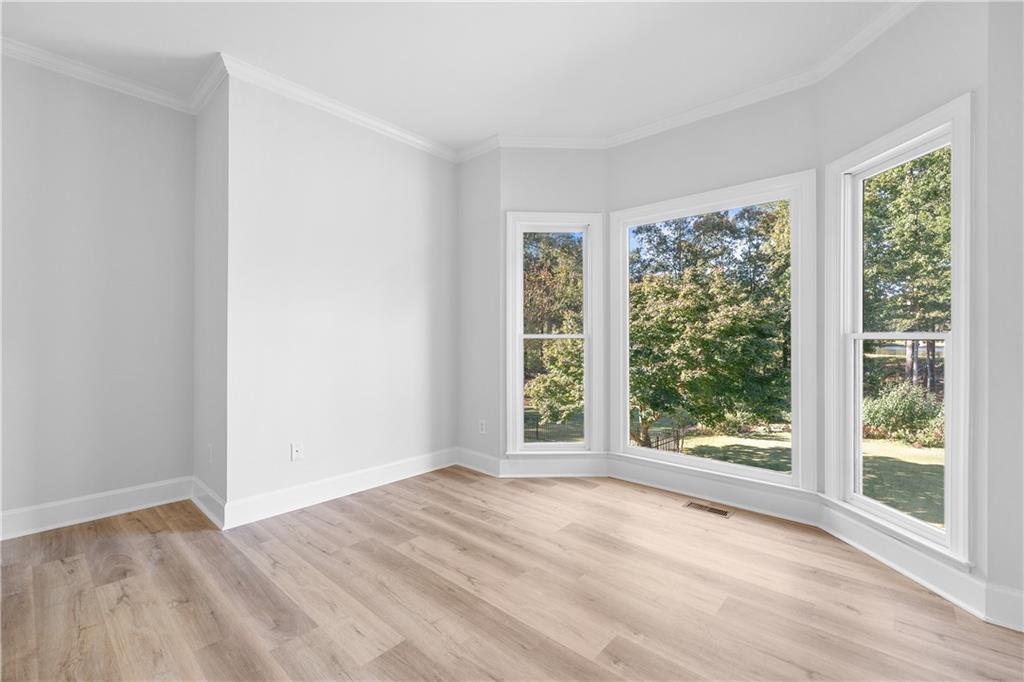 1810 Sunset Harbour Pointe Lawrenceville, GA 30043 - Photo 20 of 56 a view of an empty room with wooden floor and a window