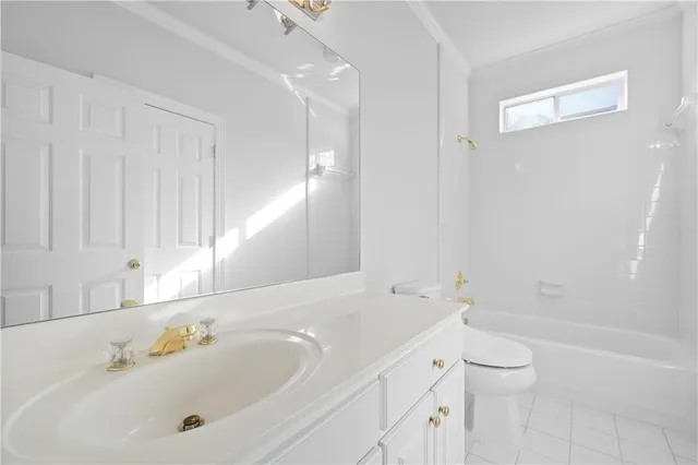 a view of an empty room with chandelier fan and wooden floor