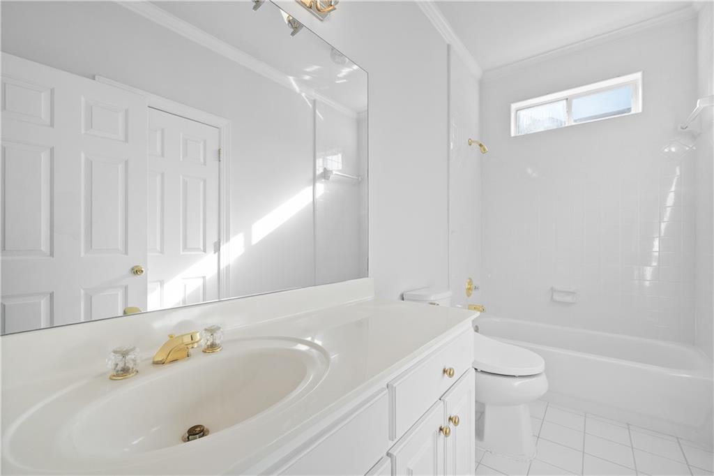 1810 Sunset Harbour Pointe Lawrenceville, GA 30043 - Photo 22 of 56 a bathroom with a bathtub shower sink and toilet