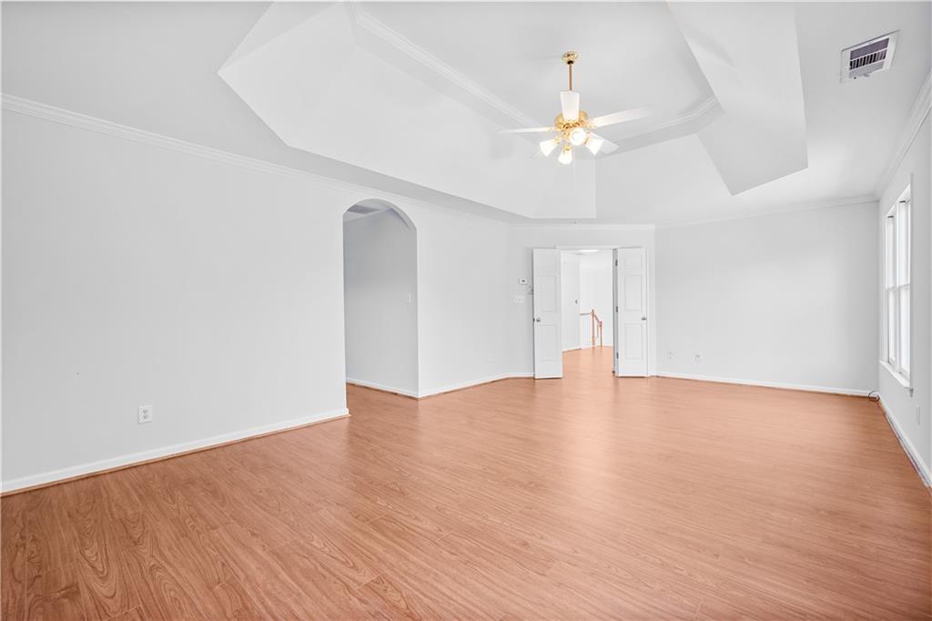 1810 Sunset Harbour Pointe Lawrenceville, GA 30043 - Photo 25 of 56 a view of an empty room with chandelier fan and wooden floor