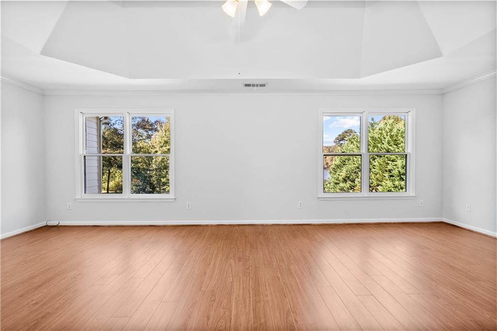 1810 Sunset Harbour Pointe Lawrenceville, GA 30043 - Photo 26 of 56 an empty room with wooden floor and windows