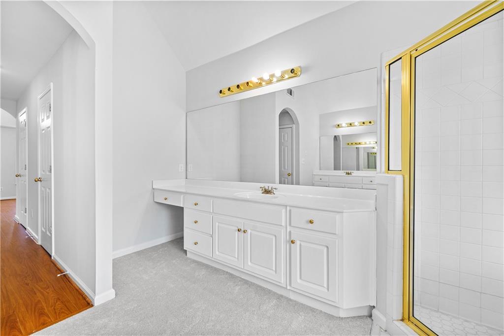 1810 Sunset Harbour Pointe Lawrenceville, GA 30043 - Photo 28 of 56 a spacious bathroom with a double vanity sink and a mirror