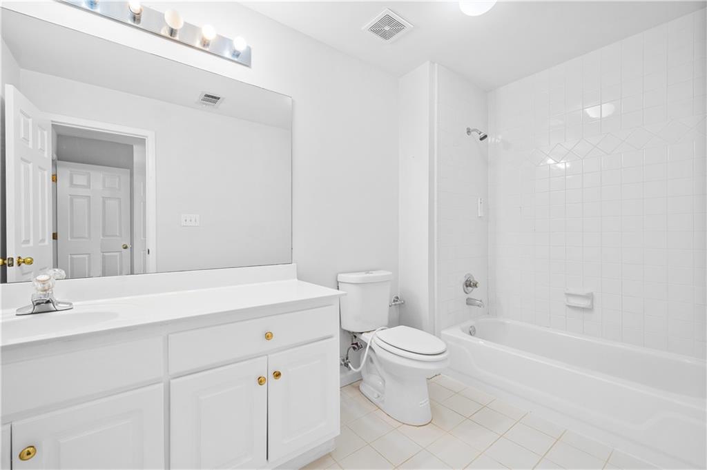 1810 Sunset Harbour Pointe Lawrenceville, GA 30043 - Photo 34 of 56 a bathroom with a sink a toilet and shower