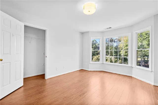 a view of a livingroom with wooden floor and cabinet