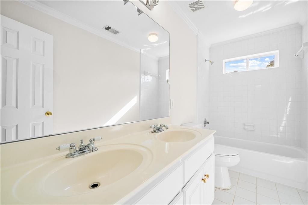 1810 Sunset Harbour Pointe Lawrenceville, GA 30043 - Photo 37 of 56 a bathroom with a sink a toilet and shower