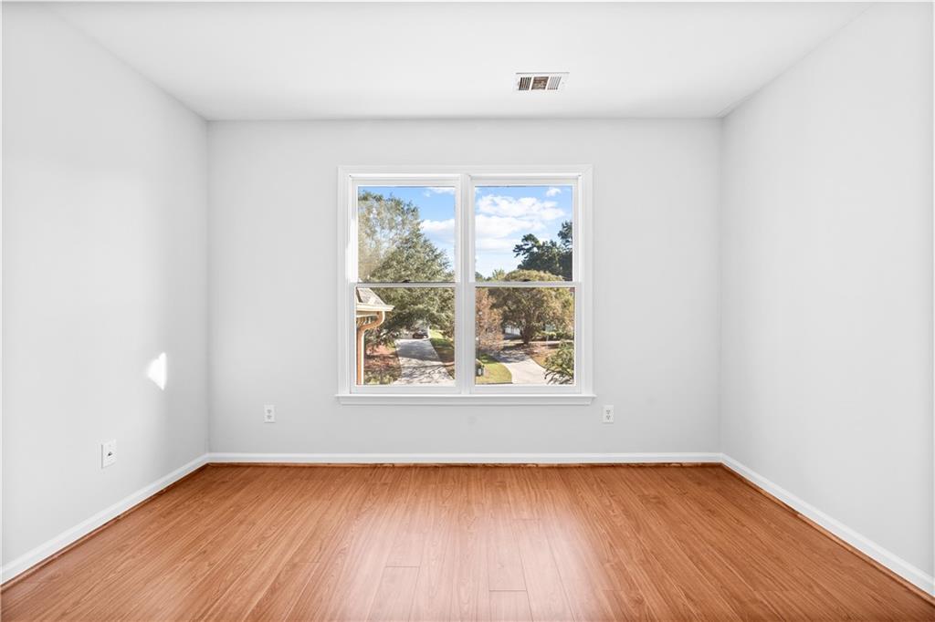 1810 Sunset Harbour Pointe Lawrenceville, GA 30043 - Photo 38 of 56 an empty room with wooden floor and windows