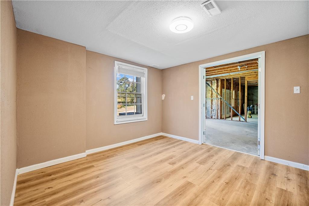 1810 Sunset Harbour Pointe Lawrenceville, GA 30043 - Photo 40 of 56 a view of an empty room with wooden floor and a window