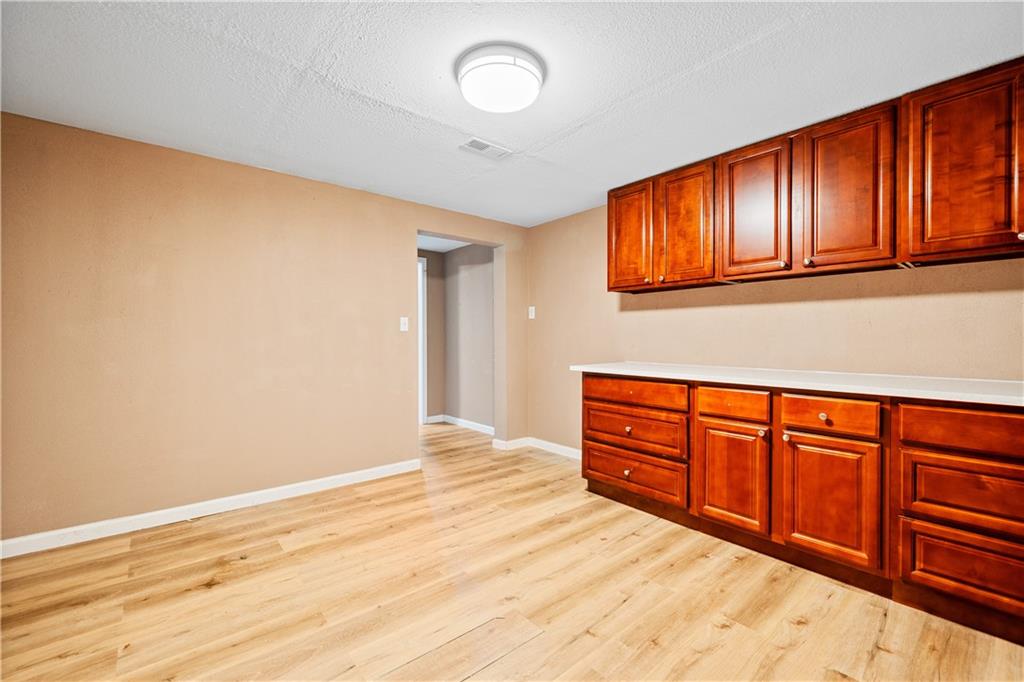 1810 Sunset Harbour Pointe Lawrenceville, GA 30043 - Photo 41 of 56 a view of a livingroom with wooden floor and cabinet