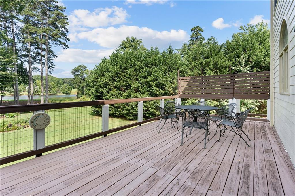 1810 Sunset Harbour Pointe Lawrenceville, GA 30043 - Photo 45 of 56 a view of a balcony with chairs and wooden floor