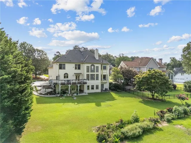 an aerial view of a house with a garden and swimming pool