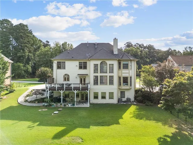 an aerial view of residential houses with outdoor space and lake view