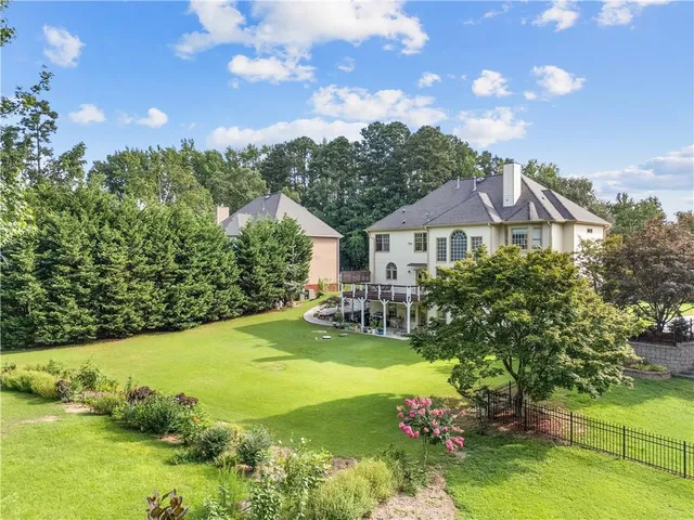 an aerial view of a house with a garden and a yard