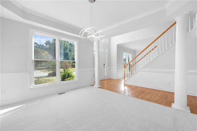 a view of entryway and hall with a chandelier