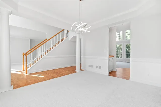 a view of an empty room with a window and fireplace