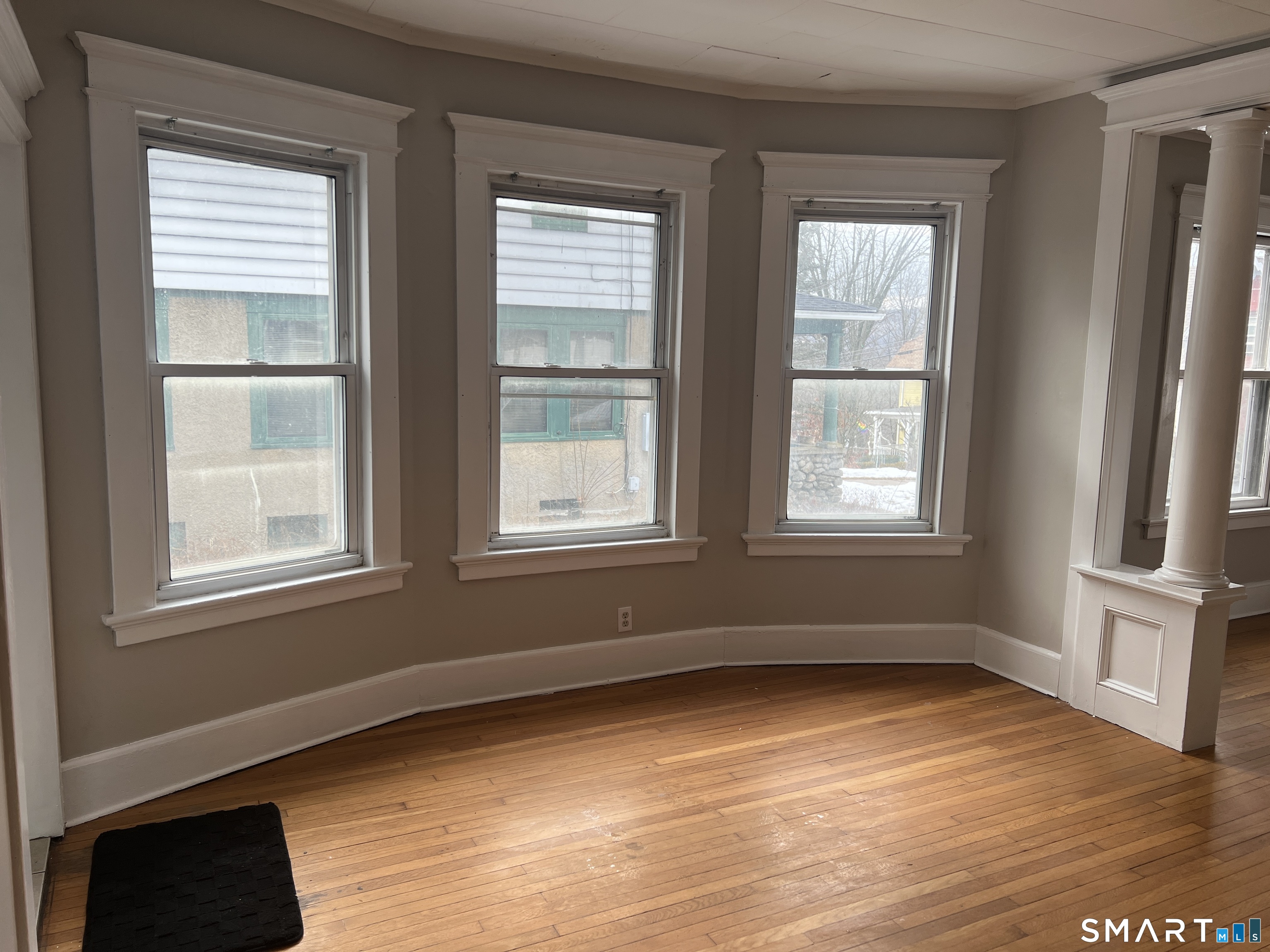 40 Prospect Street Ansonia, CT 06401 - Photo 14 of 31 an empty room with wooden floor and windows